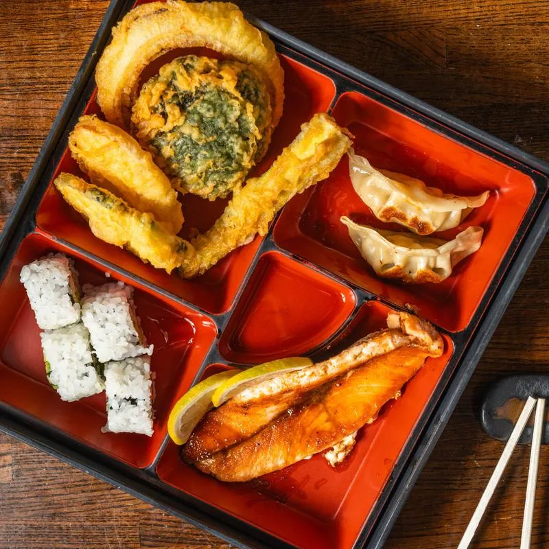Bento box with tempura, gyoza dumplings, salmon and sushi rolls at Ichiban Alpharetta
