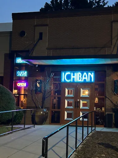 Ichiban Steak and Sushi storefront with neon hibachi and sushi signs at night in Alpharetta GA
